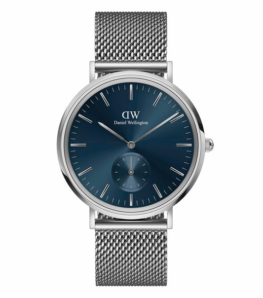 Daniel Wellington watch with black multi-eye dial, silver-tone case, and mesh strap; side-angle view showcasing sleek design.