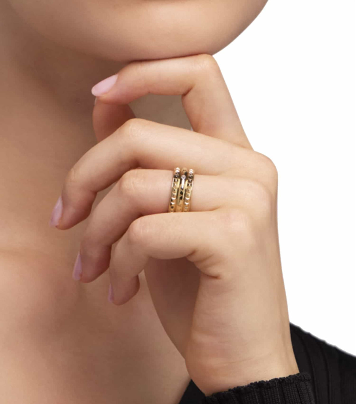 Furla gold ring, elegant design with textured cylindrical elements, top view displaying intricate craftsmanship and luxurious allure.